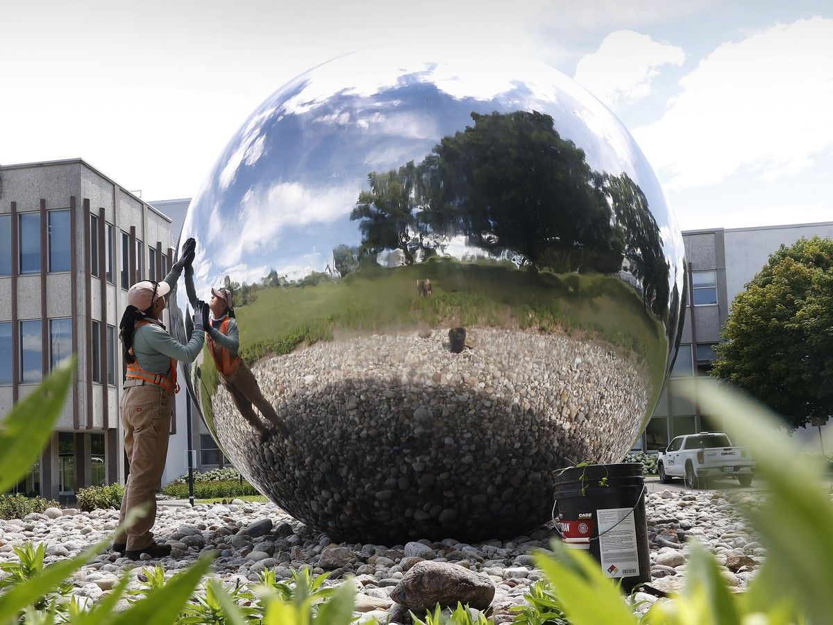 Karen Sedano, from Gemma Property Services, cleans a bit of dirt off the chrome dome while working outside the National Research Council campus in Ottawa. Karen Sedano, from Gemma Property Services, cleans a bit of dirt off the chrome dome while working outside the National Research Council campus in Ottawa.