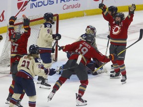 Ottawa Charge players celebrate after Rebecca Leslie scored the game-winning goal during the third period on Monday night at the Canadian Tire Centre.