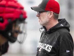 Ryan Dinwiddie, head coach and general manager of the Ottawa Redblacks, stands on the field during the team’s annual Fan Fest earlier this year.