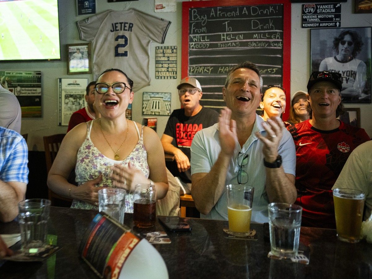 Canadian supporters, including Deborah and Paul Theriault, gathered at Pubblico Eatery to cheer on Canada's men's national soccer team during its FIFA World Cup match against South Africa