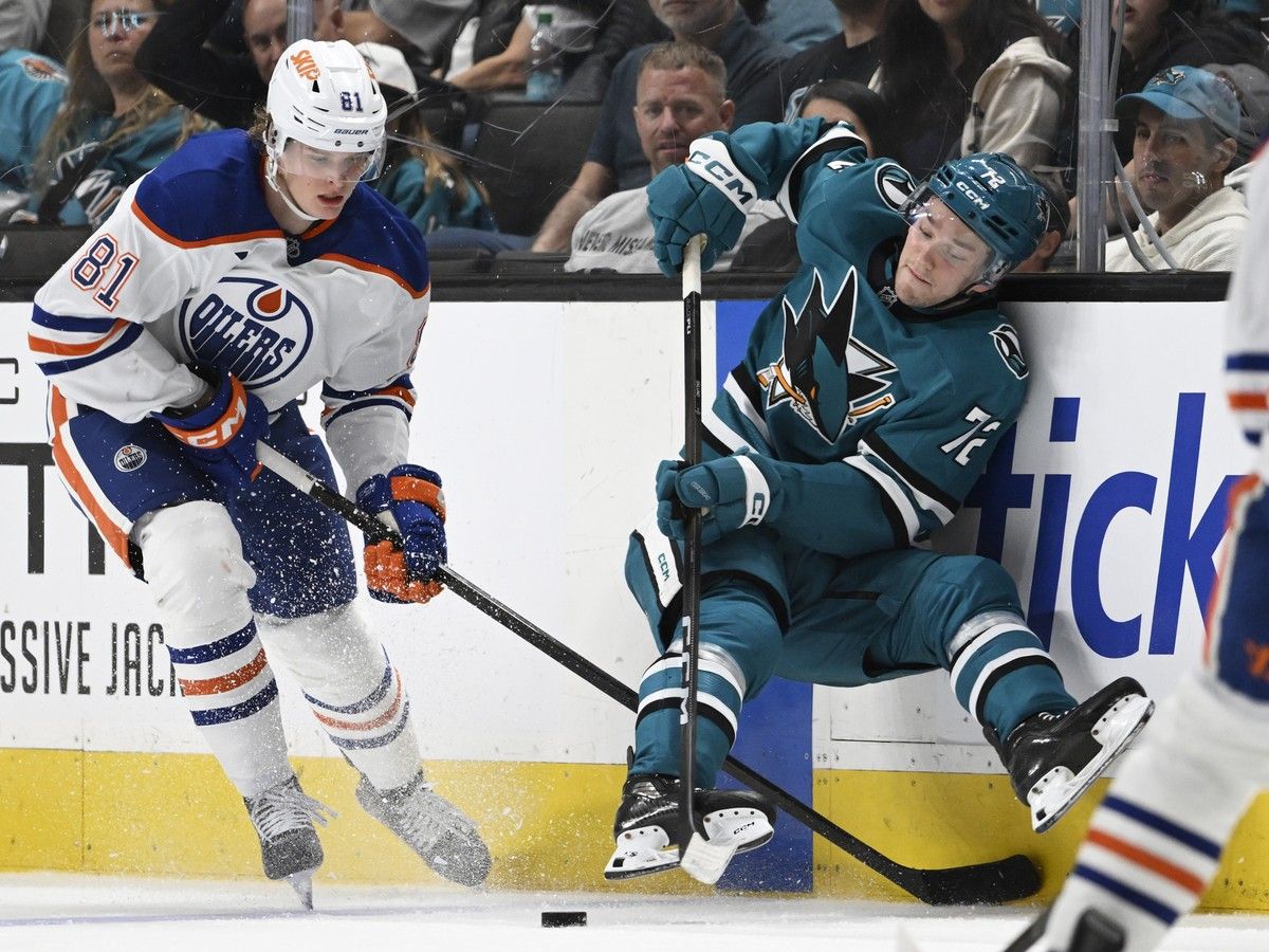 William Eklund of the San Jose Sharks and Josh Samanski of the Edmonton Oilers battle for the puck
