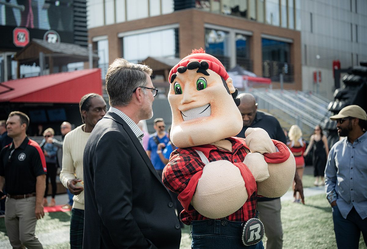 Big Joe, the Ottawa Redblacks' burly lumberjack, with head coach and general manager Ryan Dinwiddie.