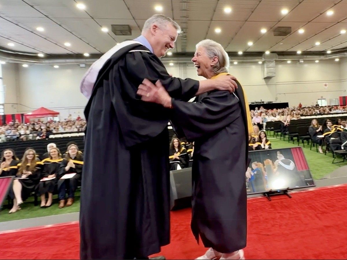  Ann Laubstein, right, accepts congratulations from Allan Thompson, co-director of the Carleton University School of Journalism and Communication and a long-time friend, at her graduation ceremony for a Bachelor of Science degree in Neuroscience and Mental Health on Thursday, June 11.