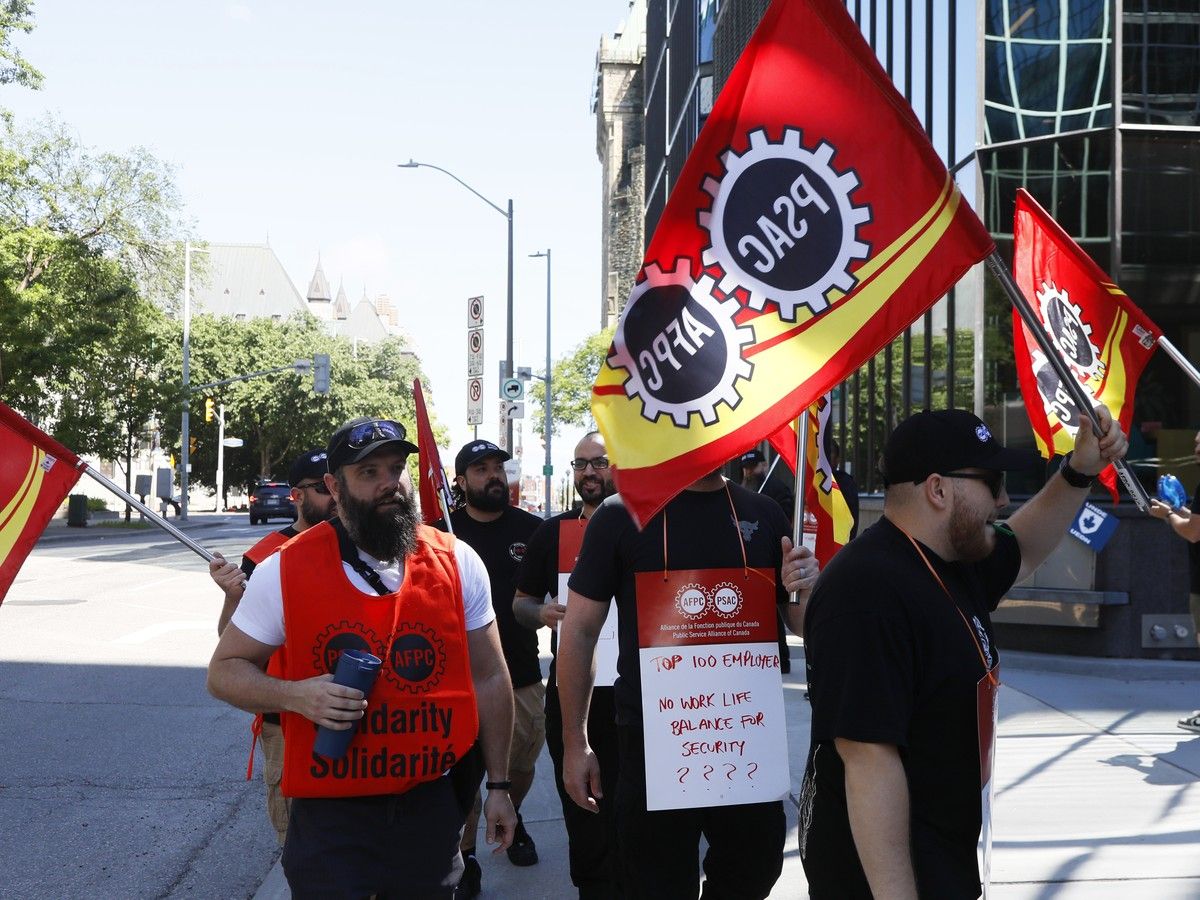 Bank of Canada security officers, members of the Public Service Alliance of Canada, walk the picket outline on June 23, 2026. Bank of Canada security officers, members of the Public Service Alliance of Canada, walk the picket outline on June 23, 2026.