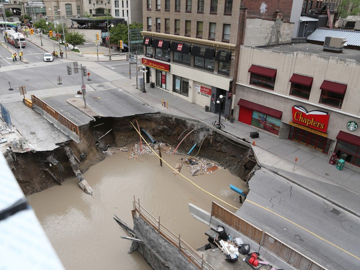 View from top of Rideau Center of sinkhole on Rideau St and gas leak in Ottawa, June 8, 2016. View from top of Rideau Center of sinkhole on Rideau St and gas leak in Ottawa, June 8, 2016.