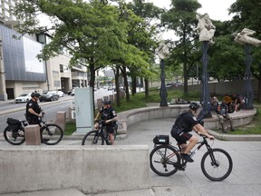 Ottawa police ride their bikes near the Circle close to the pedestrian underpass bridge