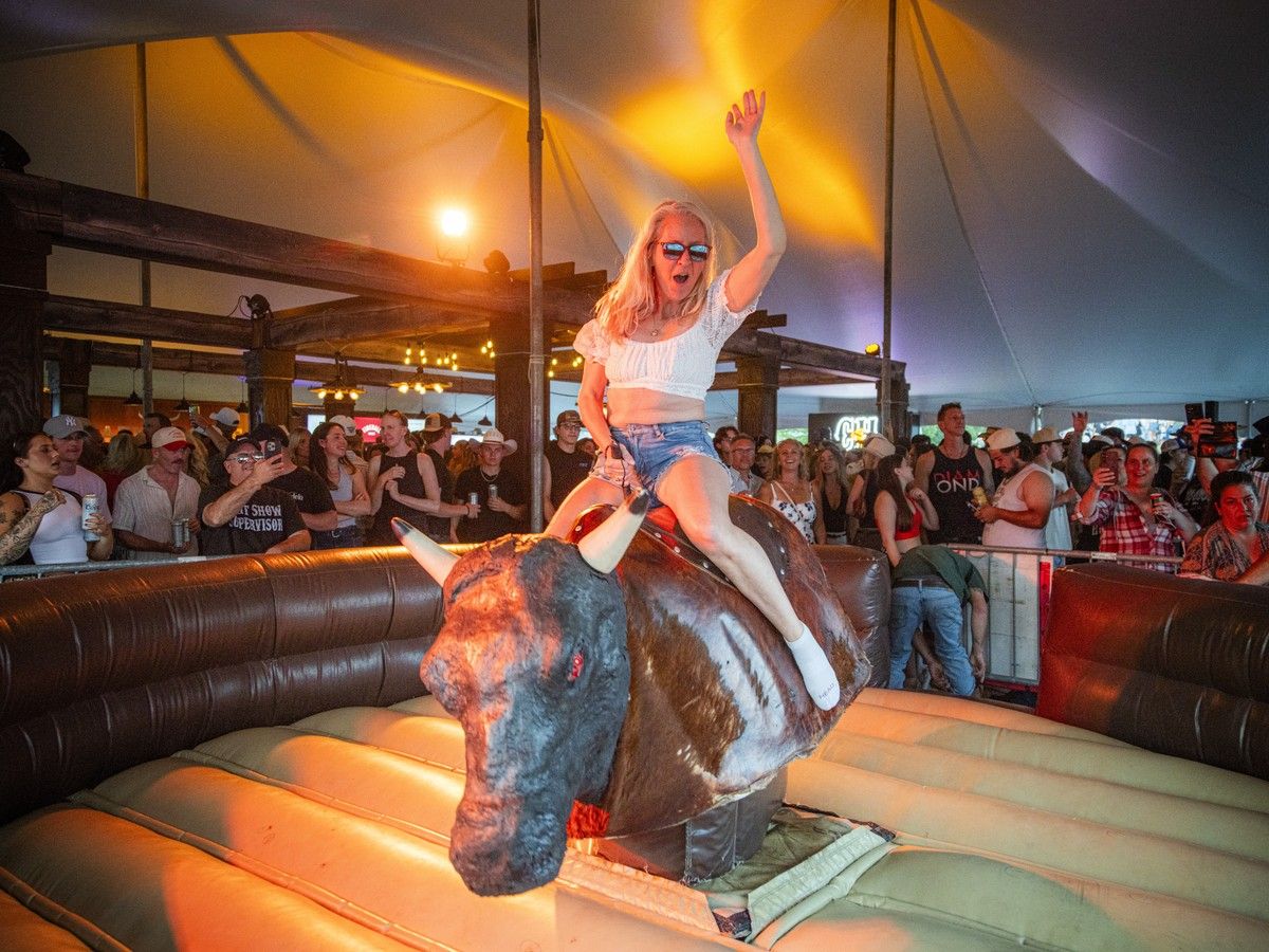 A festivalgoer tests her skills on Jed the Mechanical Bull in the Crazy Horse tent during Ottawa Bluesfest at LeBreton Flats on Saturday, July 11, 2026. A festivalgoer tests her skills on Jed the Mechanical Bull in the Crazy Horse tent during Ottawa Bluesfest at LeBreton Flats on Saturday, July 11, 2026.