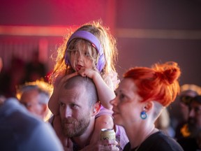A young music fan watches Here Come the Mummies perform on the LeBreton Stage during Ottawa Bluesfest at LeBreton Flats, Saturday, July 18, 2026.