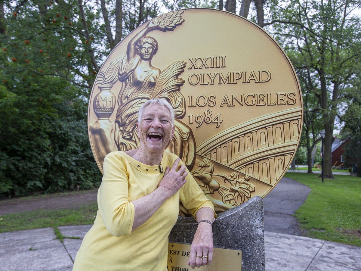  Linda Thom admires the replica Olympic gold medal that replaced the damaged one in the Old Ottawa South park named in her honour. (Credit: Bruce Deachman, Postmedia)