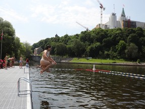 Ottawa Citizen reporter Olivia Belovich and Mike Adams enjoy diving from the East Wharf NCC swimming dock near Parliament Hill and the Rideau Locks, July 01, 2026