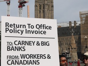 A return to office policy invoice was delivered to government officials as unions and supporters against return to office policies gathered in Ottawa, July 06, 2026. Photo by Jean Levac/Ottawa Citizen