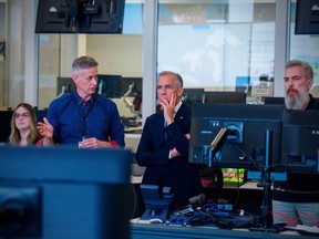 Prime Minister Mark Carney speaks to a public servant at the Government Operations Centre
