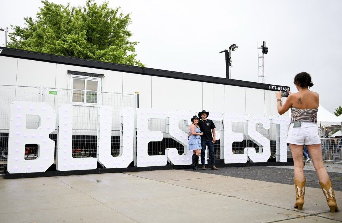 Fans take a picture in front of a Bluesfest sign during the opening night of Bluesfest at LeBreton Flats on Thursday, July 9, 2026. Fans take a picture in front of a Bluesfest sign during the opening night of Bluesfest at LeBreton Flats on Thursday, July 9, 2026.