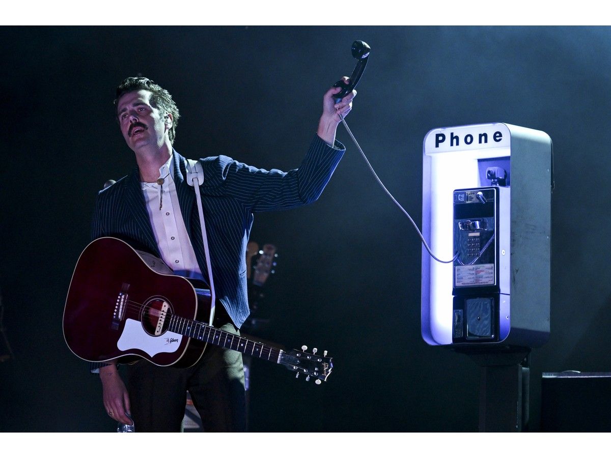 Lord Huron singer Ben Schneider with a pay phone on stage at Bluesfest