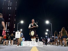 Bagpiper Nico Gravel performs as attendees to Bluesfest depart LeBreton Flats.
