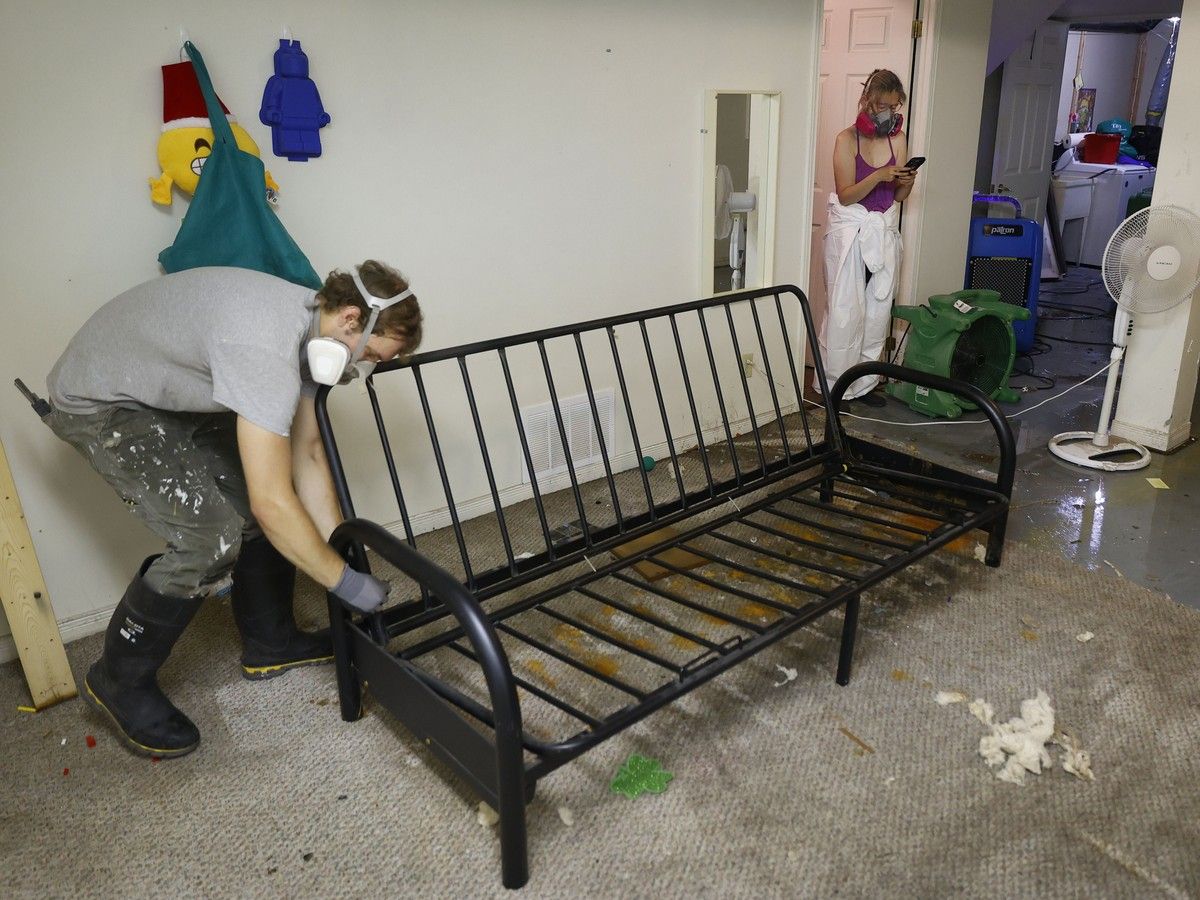 Lisa Gee takes photos of her damaged flooded basement on Saxton Private. Lisa Gee takes photos of her damaged flooded basement on Saxton Private.