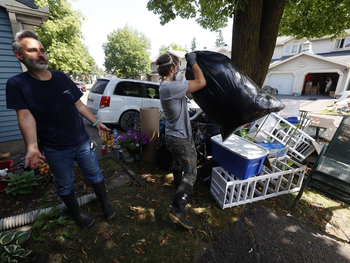 Homeowner Benjamin Borg (left) and a crew take out damaged items from his flooded basement on Saxton Private. Homeowner Benjamin Borg (left) and a crew take out damaged items from his flooded basement on Saxton Private.