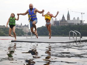 OTTAWA - July 13, 2026-- Jonathan Jobin and his daughters, Isabelle and Mila, cool off in the Ottawa River at the new dock near the Museum of History in Gatineau. TONY CALDWELL, Postmedia.