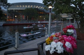 Kayakers pass between 1Elgin restaurant and the Rogers Centre.