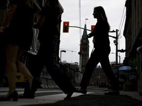 The silhouette of a person walking in downtown Ottawa.