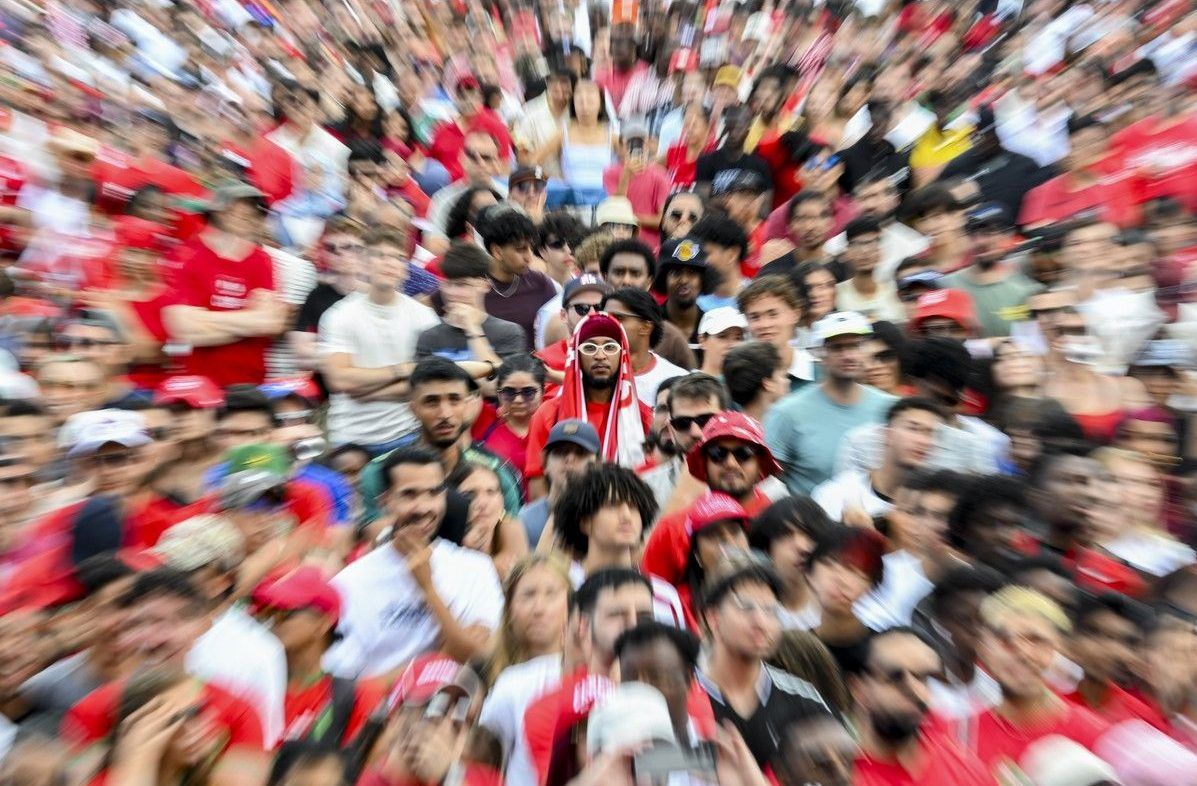 A fan draped in a Canadian flag looks on during the watch party Saturday. A fan draped in a Canadian flag looks on during the watch party Saturday.