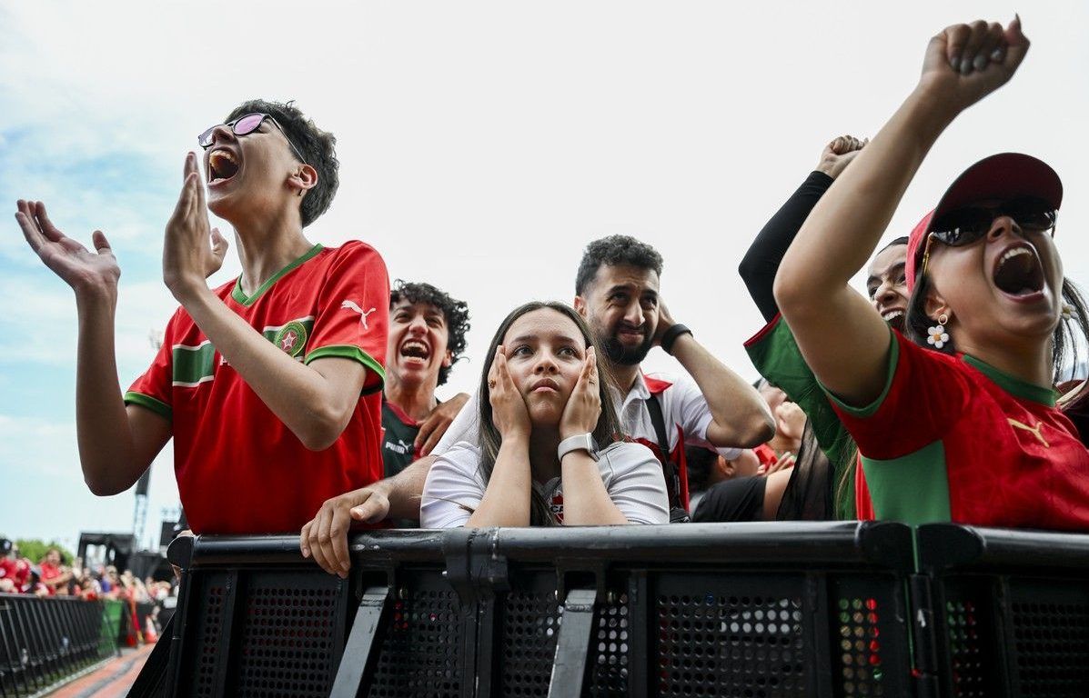 A Canadian fan is flanked by Moroccan fans as they celebrate a goal during the watch party at LeBreton Flats on Saturday, July 4, 2026. A Canadian fan is flanked by Moroccan fans as they celebrate a goal during the watch party at LeBreton Flats on Saturday, July 4, 2026.