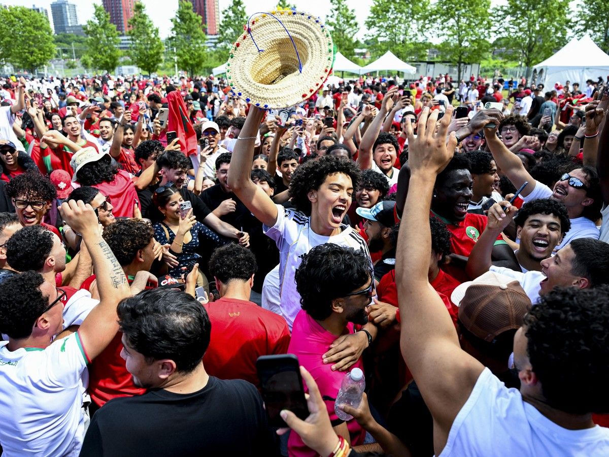 Moroccan fans celebrate following their team’s win over Canada. Moroccan fans celebrate following their team’s win over Canada.