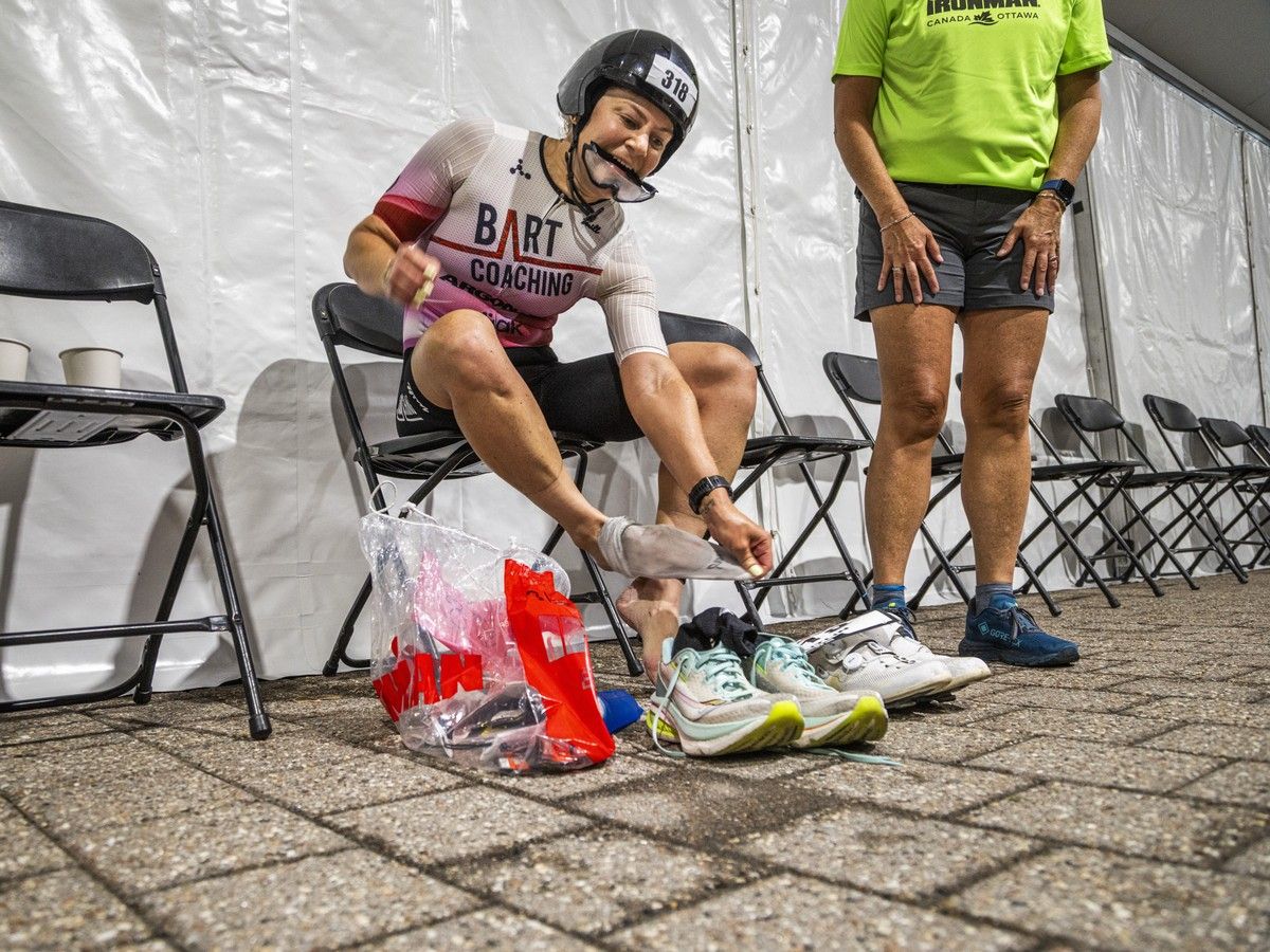 Caitlin Gulik switches her shoes in the transition zone Sunday. Caitlin Gulik switches her shoes in the transition zone Sunday.
