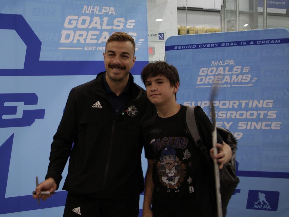 Former Ottawa Senators forward Jean-Gabriel Pageau with a young fan.