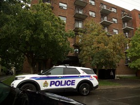 An Ottawa police vehicle sits outside 234 Guigues Ave. in Lowertown on a rainy Sunday, Aug. 23, 2026, as police investigate a suspicious death.