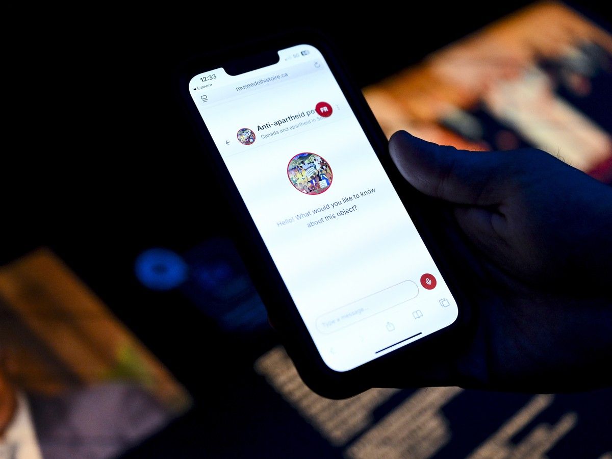 Reporter Michael McBean reads information from a MUSEO AI chatbot at the Canadian Museum of History in Gatineau on Monday, Aug. 3, 2026.