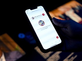 Reporter Michael McBean reads information from a MUSEO AI chatbot at the Canadian Museum of History in Gatineau on Monday, Aug. 3, 2026.