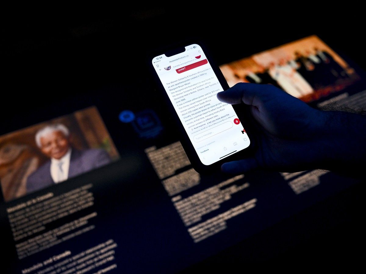 Reporter Michael McBean reads information from a MUSEO AI chatbot at the Canadian Museum of History in Gatineau on Monday, Aug. 3, 2026.