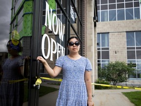 Owner of Moo & Bean Cafe Chi Blondin, poses for a portrait outside of her damaged store.