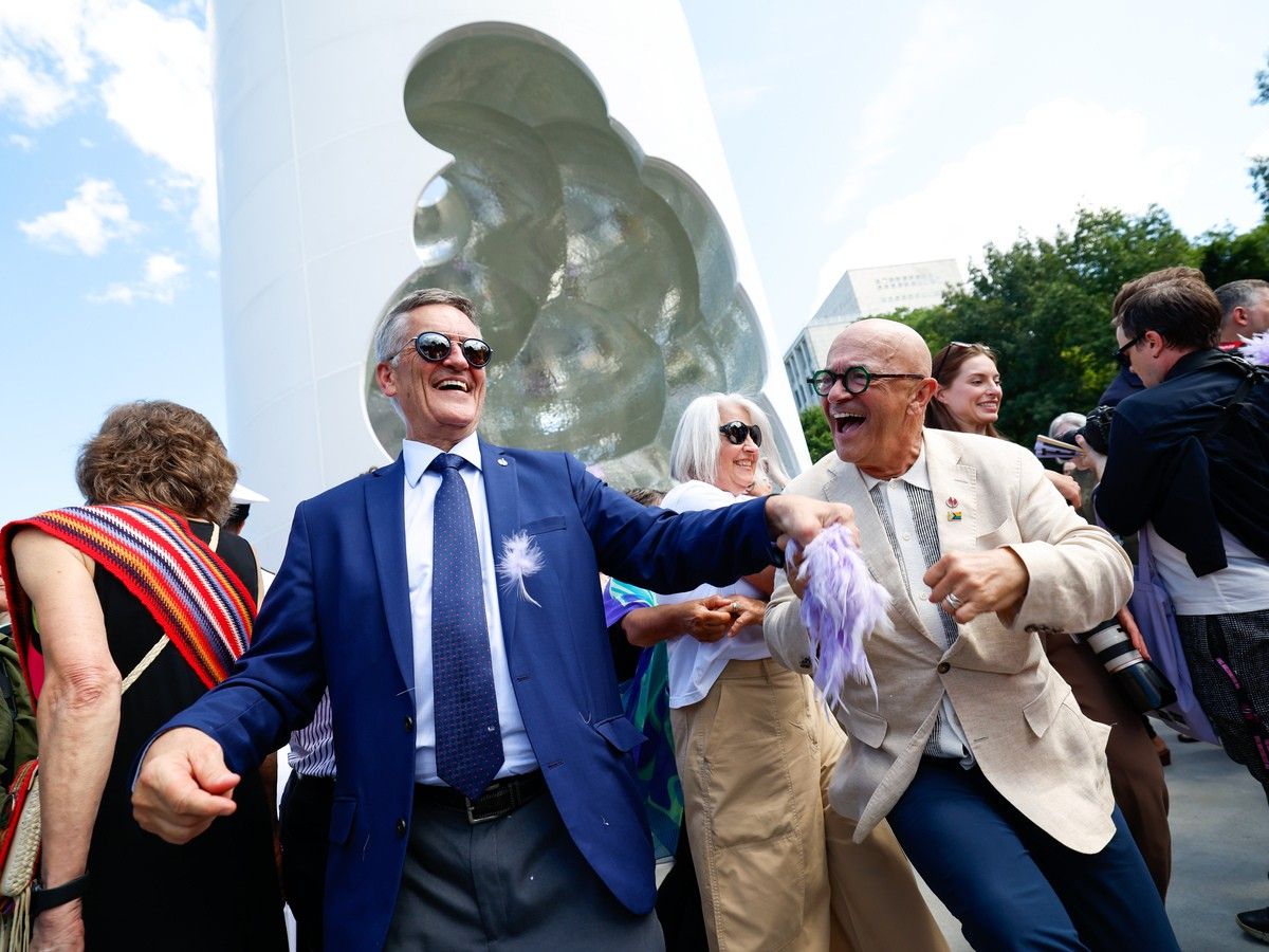 Former MP Svend Robinson and Senator René Cormier dance together at the end of the opening ceremony of the national 2SLBGTQI+ monument known as Thunderhead on Friday. Former MP Svend Robinson and Senator René Cormier dance together at the end of the opening ceremony of the national 2SLBGTQI+ monument known as Thunderhead on Friday.