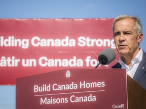 Prime Minister Mark Carney speaks at a podium that reads
