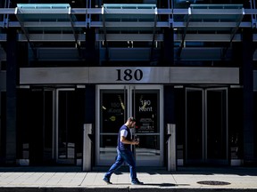 A person walks past a federal government office building.