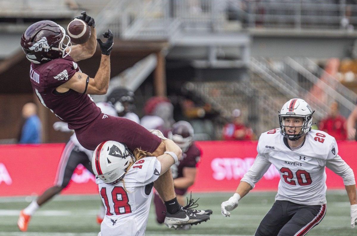  The Carleton Ravens take on the University of Ottawa Gee-Gees in the annual Panda Game at TD Place in Ottawa on Sunday, Oct. 4, 2026. Gee-Gee Robin Collioud jumps to catch the ball as Raven Jake Henderson wraps up his legs.