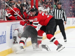 Anthony Mantha of the New Jersey Devils hits Nikolas Matinpalo of the Ottawa Senators into the boards during the first period at the Prudential Center on Monday night.