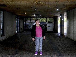 Diane stands in the dim front entrance of her apartment building.