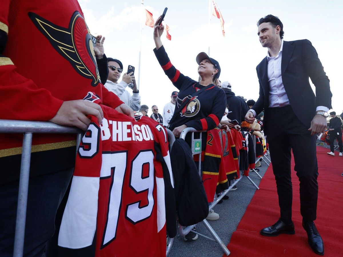 An Ottawa Senators fan gets a selfie with forward Drake Batherson during the red-carpet entrance on Thursday. An Ottawa Senators fan gets a selfie with forward Drake Batherson during the red-carpet entrance on Thursday.