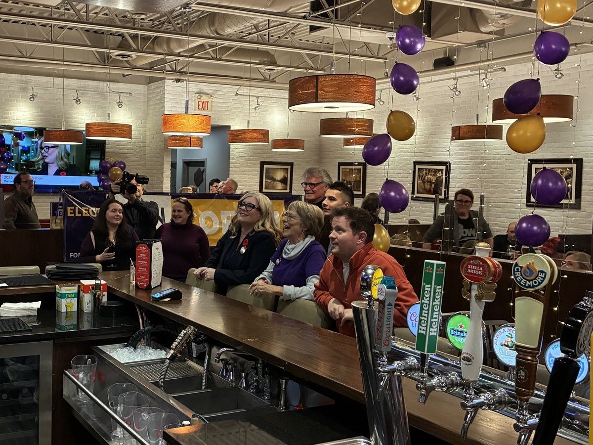 Erin Coffin, in black with a poppy at the bar, watches news coverage with supporters as the results start to roll in at Gabriel Pizza in Kanata on Monday.