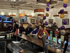 Erin Coffin, in black with a poppy at the bar, watches news coverage with supporters as the results start to roll in at Gabriel Pizza in Kanata on Monday.