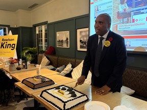 Rawlson King cuts his victory cake following his acceptance speech. Rawlson King cuts his victory cake following his acceptance speech.