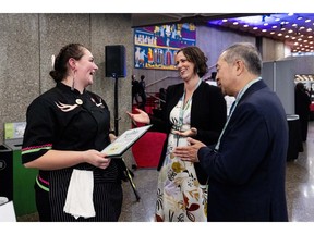 Ottawa Citizen food critic Peter Hum, right, and editor-in-chief of the Ottawa Citizen Nicole Feriancek, centre, meet with Sierra Conboy of Tuktu Catering during the Ottawa Citizen Best Restaurants 2026 event at the National Arts Centre on Monday, Oct. 19, 2026. Photo by Spencer Colby/Postmedia