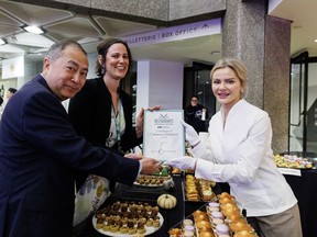 Editor-in-chief of the Ottawa Citizen Nicole Feriancek, centre, and Ottawa Citizen restaurant critic Peter Hum, left, present Elina Olefirenko of Elina Patisserie restaurant with a Certificate of Culinary Excellence award during the Ottawa Citizen Best Restaurants 2026 at the National Arts Centre on Monday.