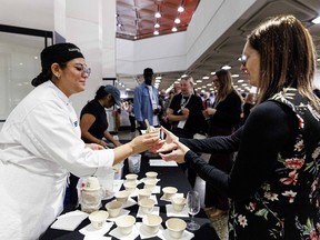 An Algonquin College culinary program student serves ice cream from Moo Shu Ice Cream to a guest at the Ottawa Citizen Best Restaurants 2026 at the National Arts Centre on Monday.