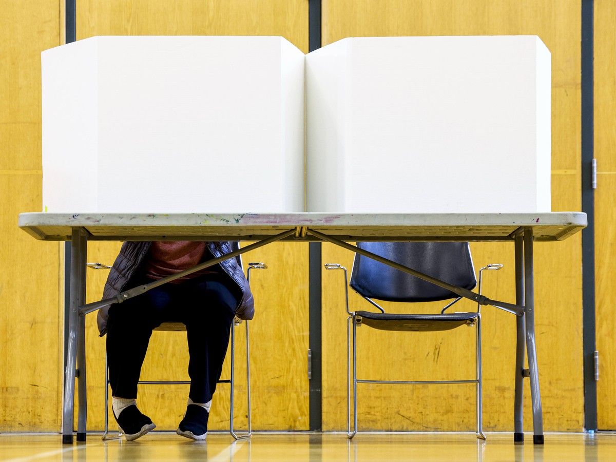 A voter casts their vote at the Don Gamble Community Centre in Rideau-Vanier ward Monday.