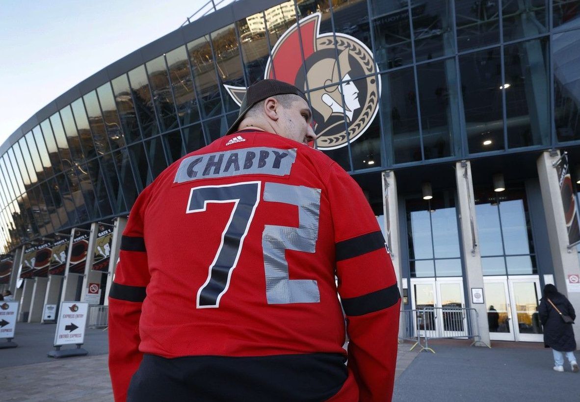 Ottawa Senators fans arrive for Wednesday's game at the Canadian Tire Centre after making changes to their Brady Tkachuk jerseys.