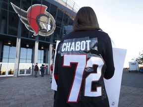 Ottawa Senators fans arrive for Wednesday's game at the Canadian Tire Centre after making changes to their Brady Tkachuk jerseys.